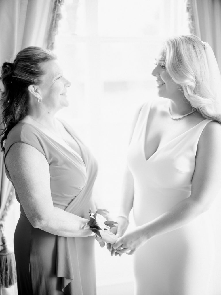 The bride shares a look with her mother before the Brecknock Hall Wedding begins.