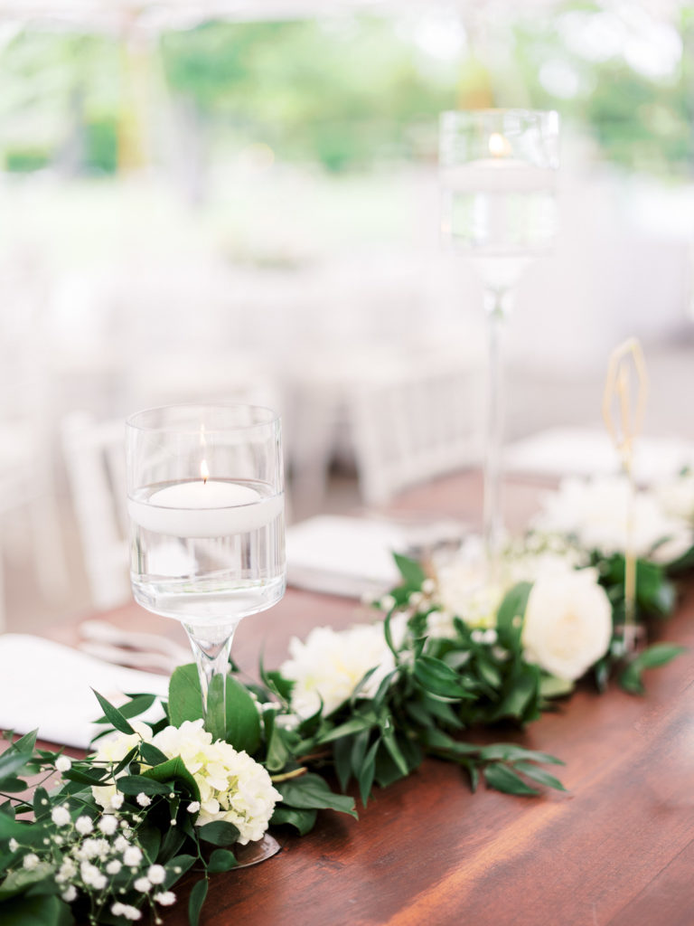 Reception details with flowers by Kim Jon designs outside the tent in Brecknock Hall