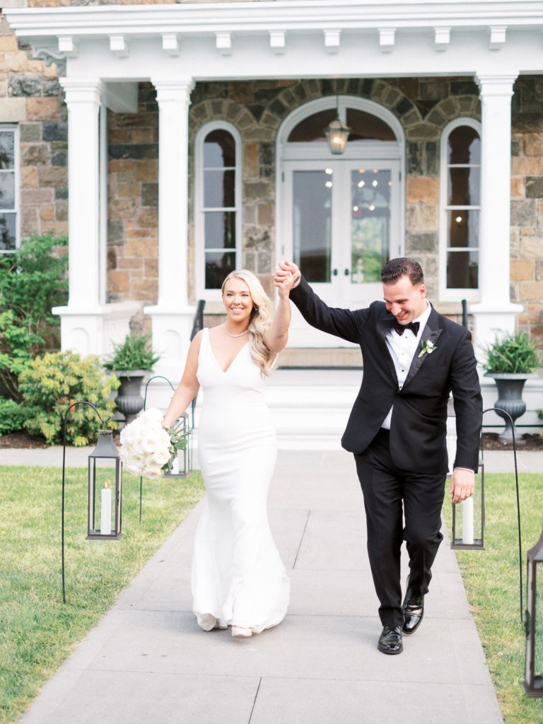 The bride and groom wearing pronovias and The Black Tux with flowers by Kim Jon designs are introduced during their Brecknock Hall Wedding Reception