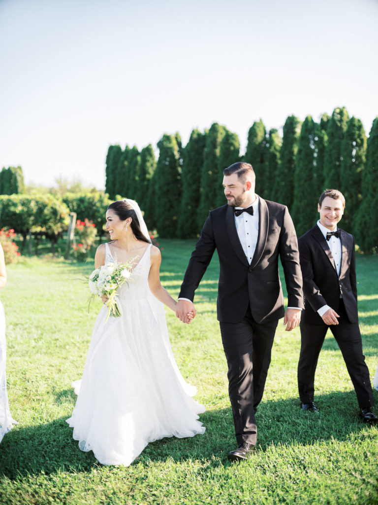 Bride and groom walk together during their Long Island Vineyard Wedding.