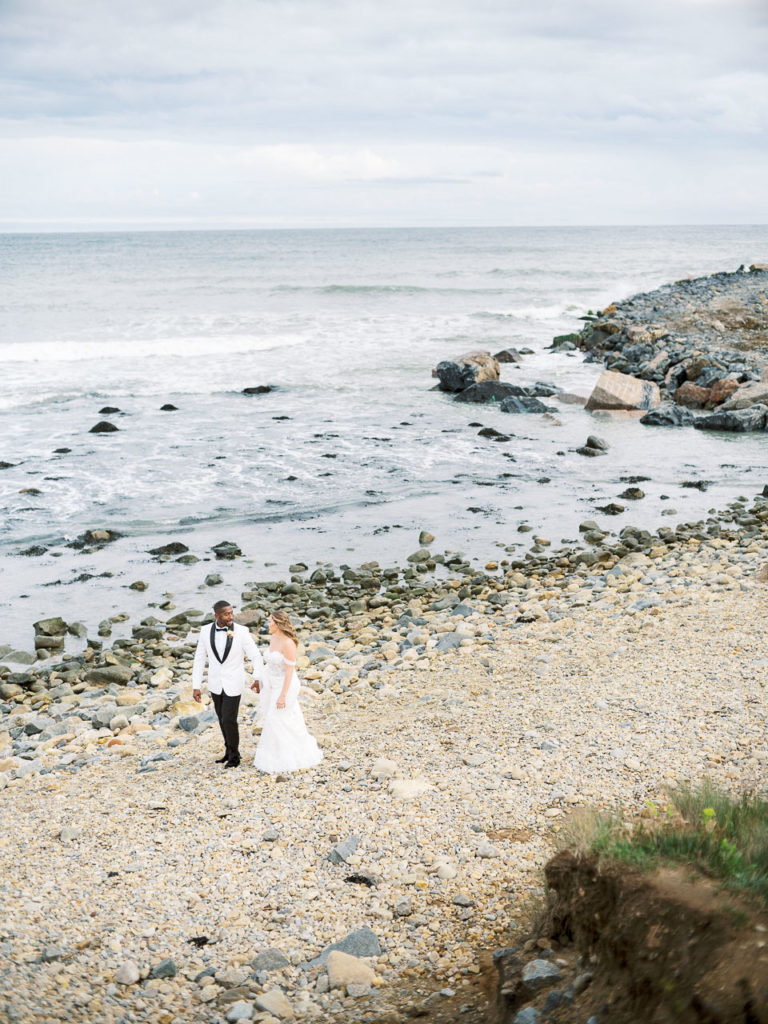 Bride and groom walk the beach during their Montauk wedding.