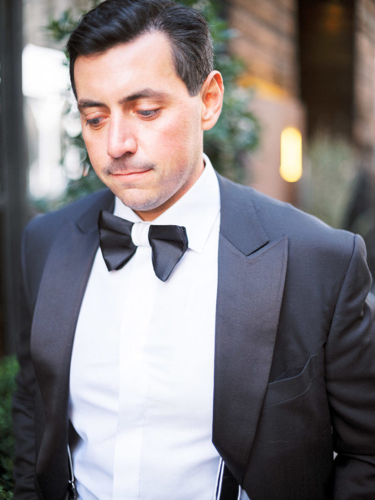Groom in The Black Tux waits outside 1 Hotel NYC for bride before The Central Park Boathouse Wedding.