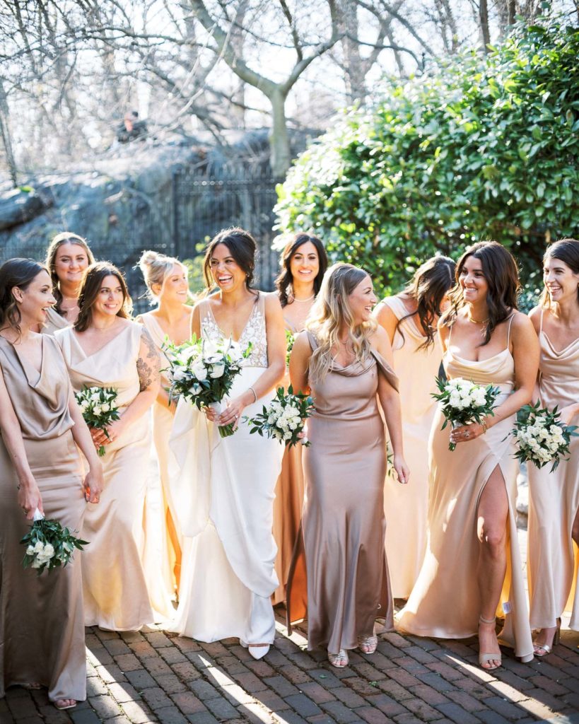 Bridesmaids walk together outside The Central Park Boathouse Wedding.