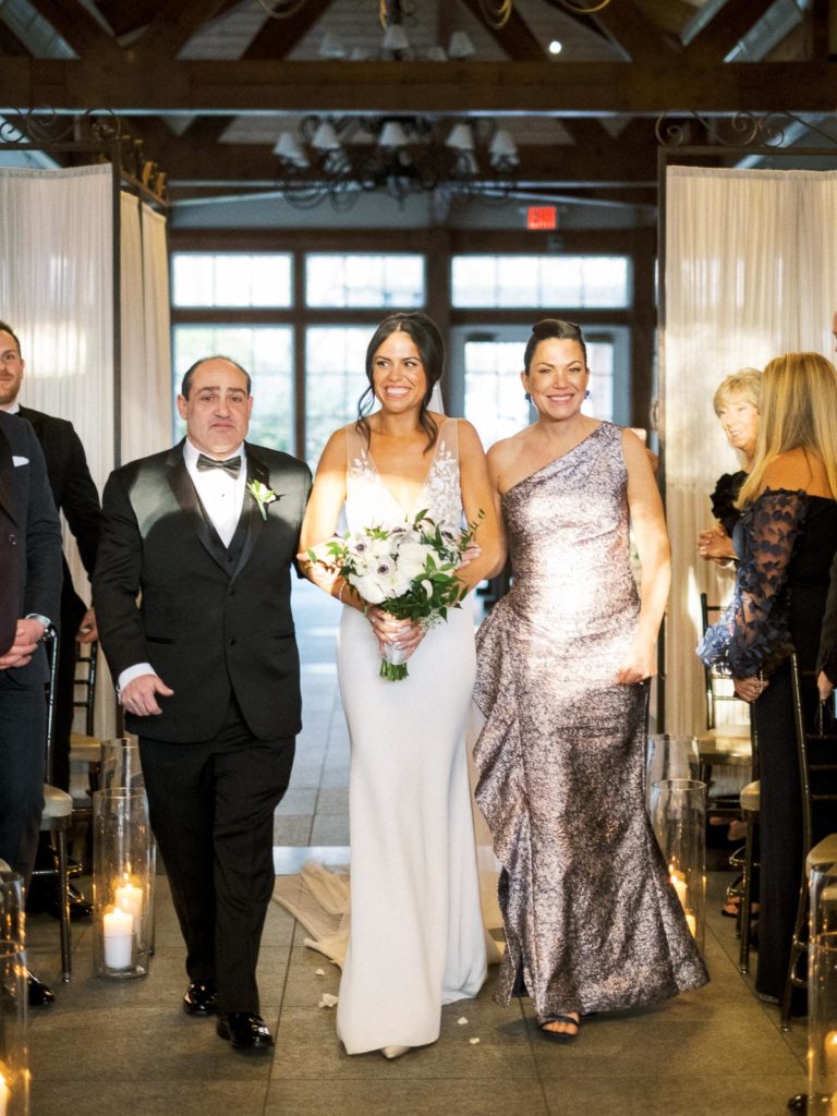 The Central Park Boathouse Wedding Ceremony bride walks down aisle.