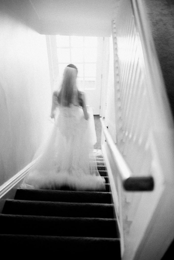 bride getting ready walking down stairs