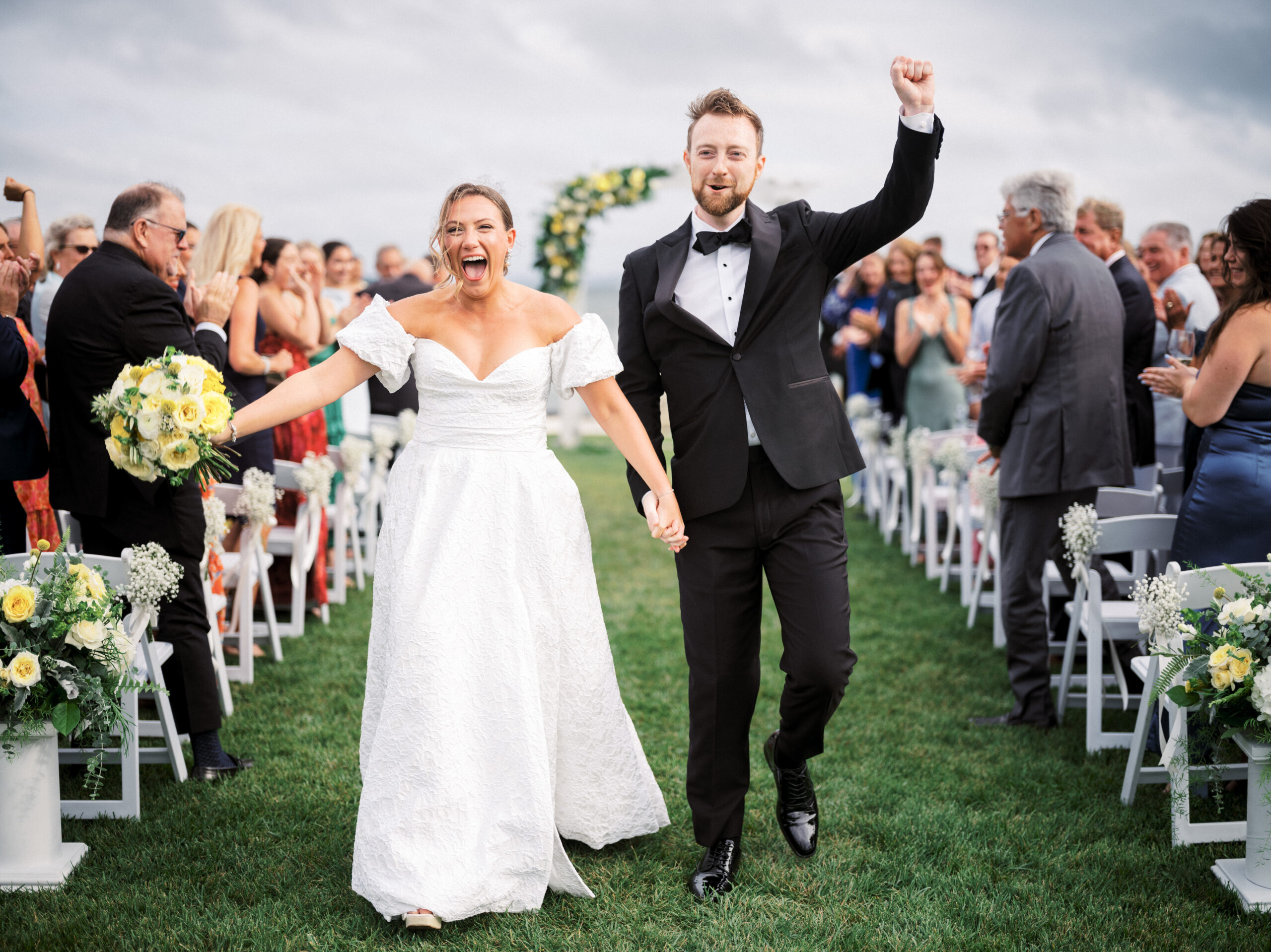 Bride and groom walk down aisle at Peconic Bay Yacht Club.