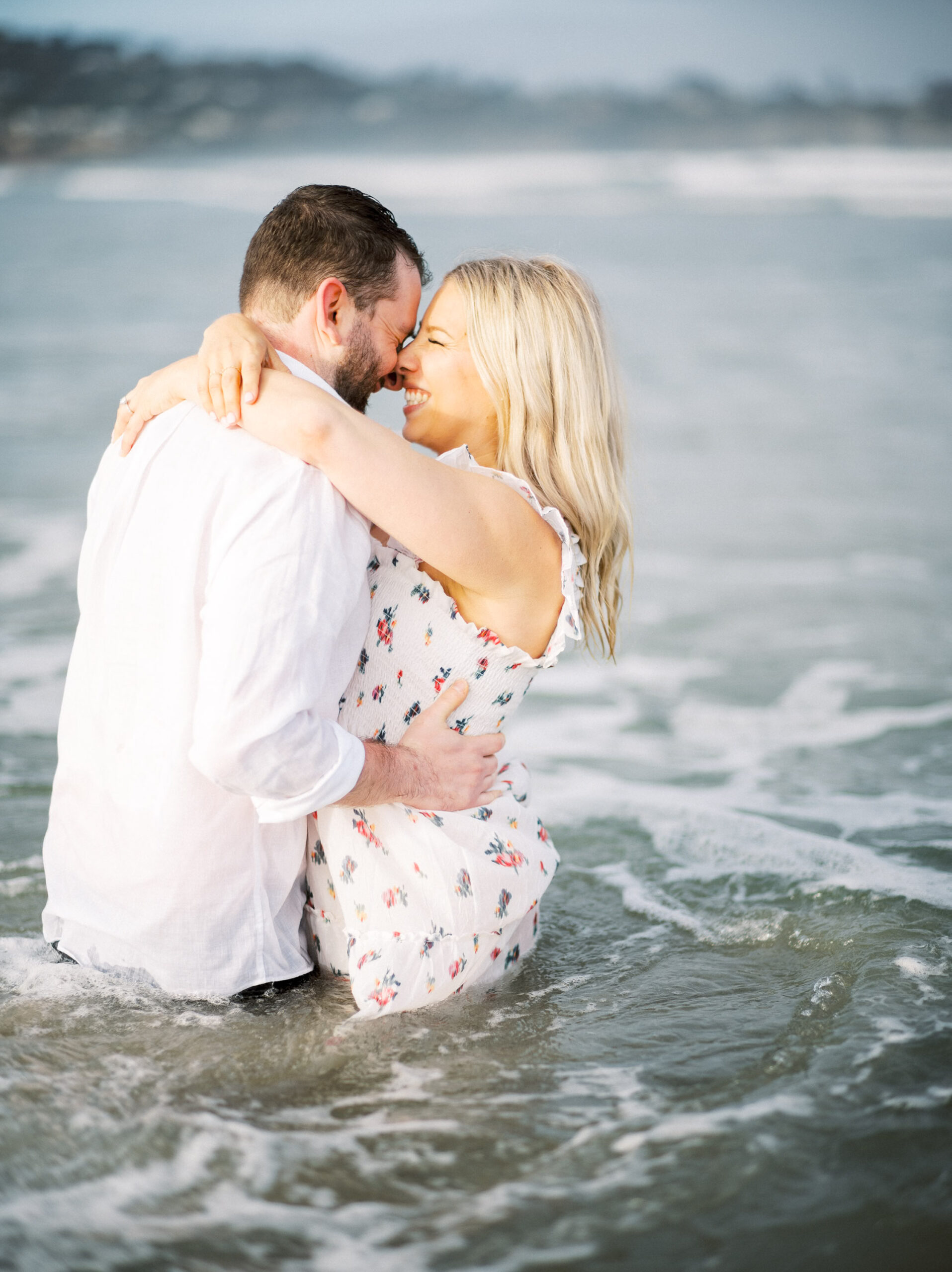 Amanda & Dan embrace while in the water at Scripps.